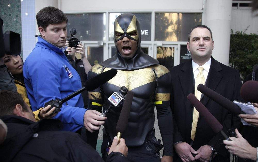 In this Oct. 13, 2011 file photo, Benjamin Fodor, centre, a self-styled superhero who goes by the name Phoenix Jones, talks to reporters after he appeared in court in Seattle.