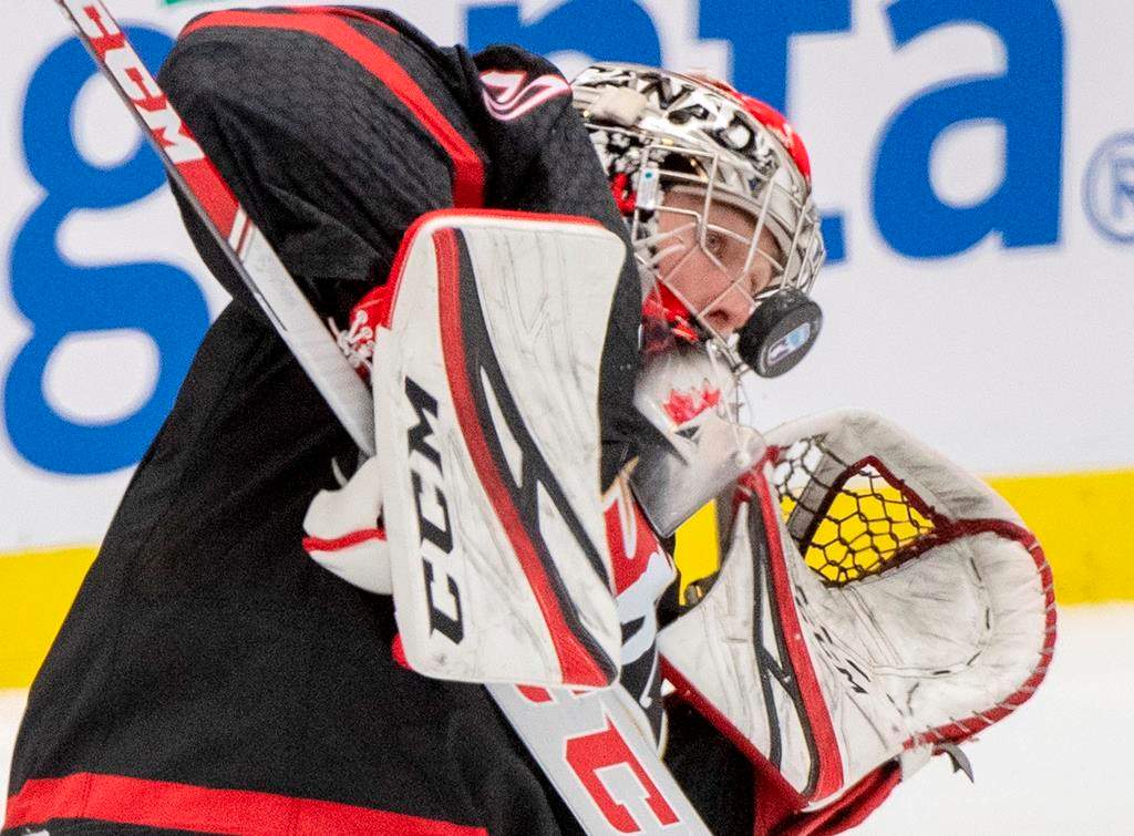 Canada goaltender Joel Hofer takes a shot off the mask during third-period semifinal action against Finland at the world junior hockey championship on Saturday, Jan. 4, 2020 in Ostrava, Czech Republic. THE CANADIAN PRESS/Ryan Remiorz