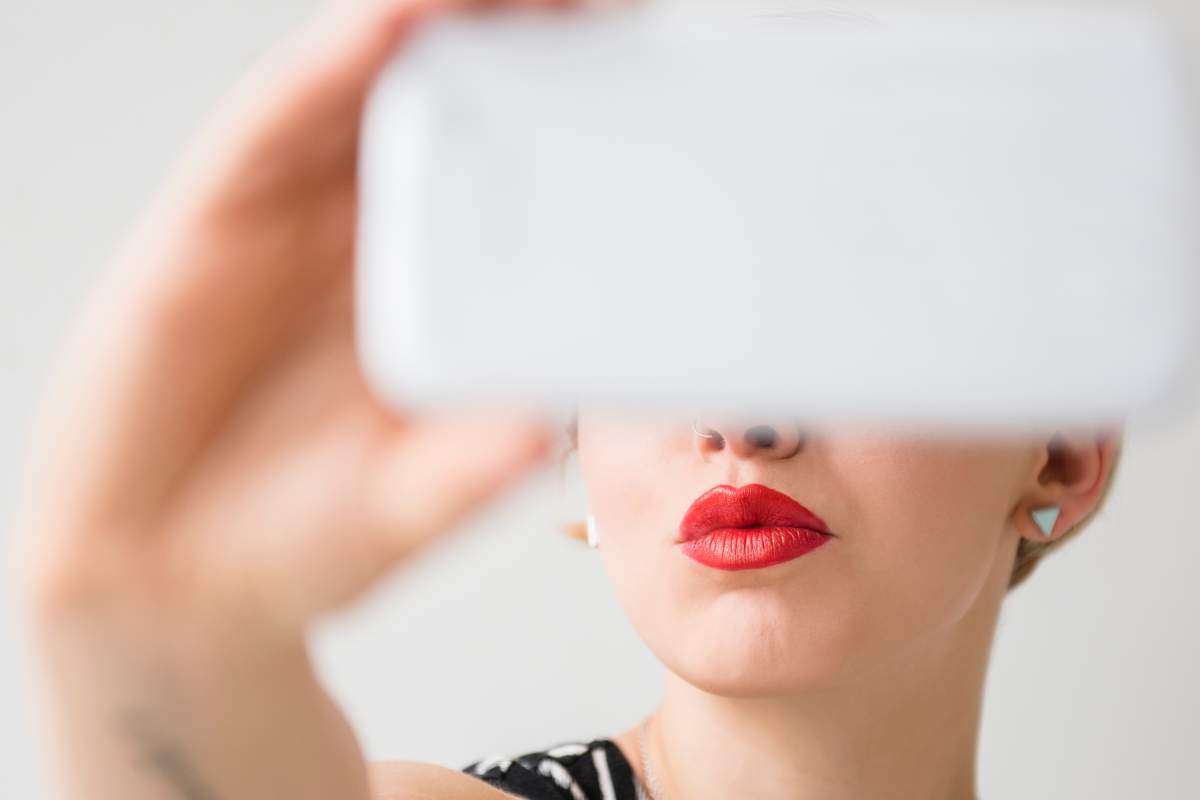 A Brandon woman who was supposed to be under a curfew outed herself by posting selfies over the weekend, police say.
