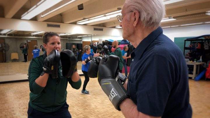 Rock Steady Boxing coach Carmen Agar works with a new member on Jan. 15, 2020.