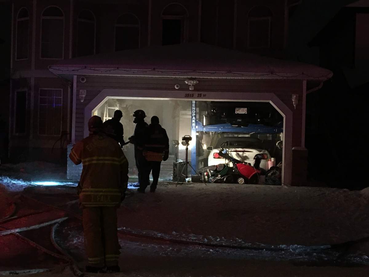 Edmonton firefighters battle a blaze at a house in the area of 35 Avenue and 25 Street on Thursday, Jan. 16, 2020.