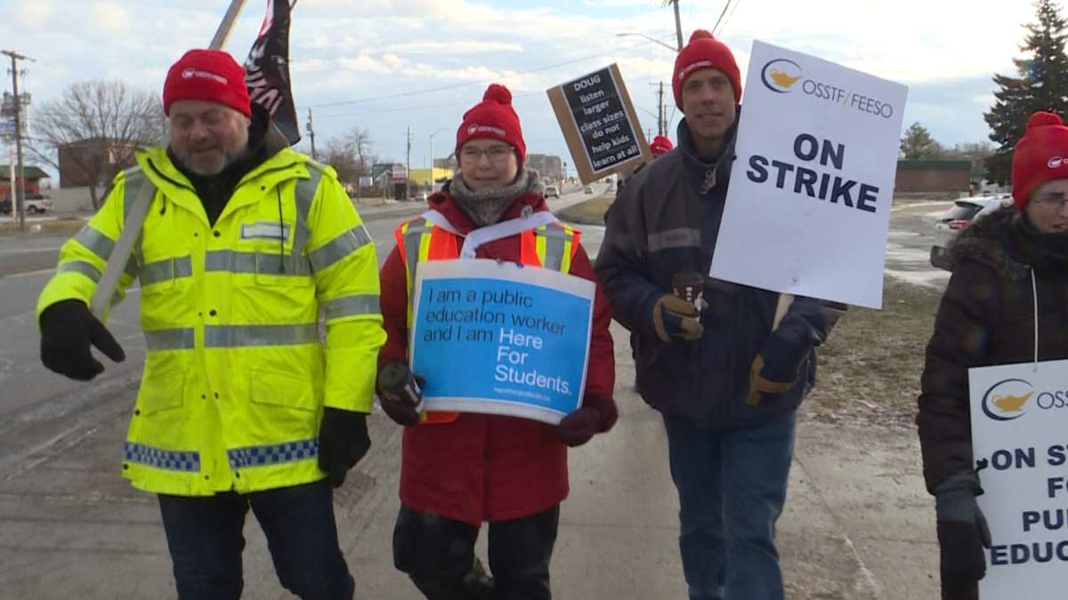 James Griffith (left), a teacher at Frontenac Secondary School in Kingston walks with colleagues.