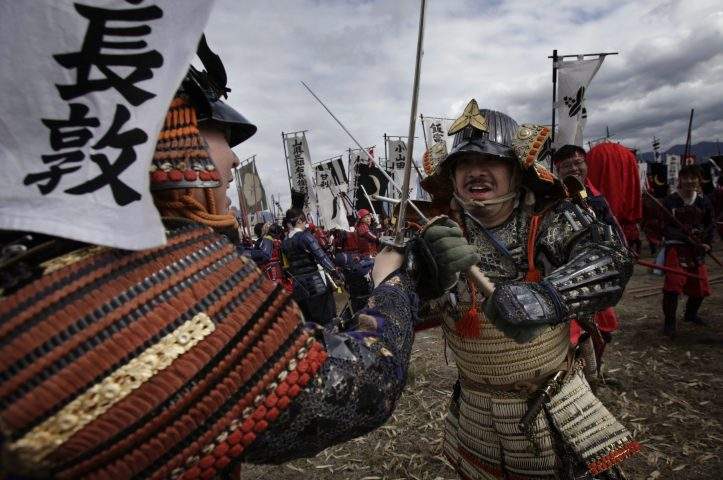 In this file photo, men in samurai attires engage in a sword fighting to re-enact the Battle of Kawanakajima in Japan on Apr. 21, 2013.