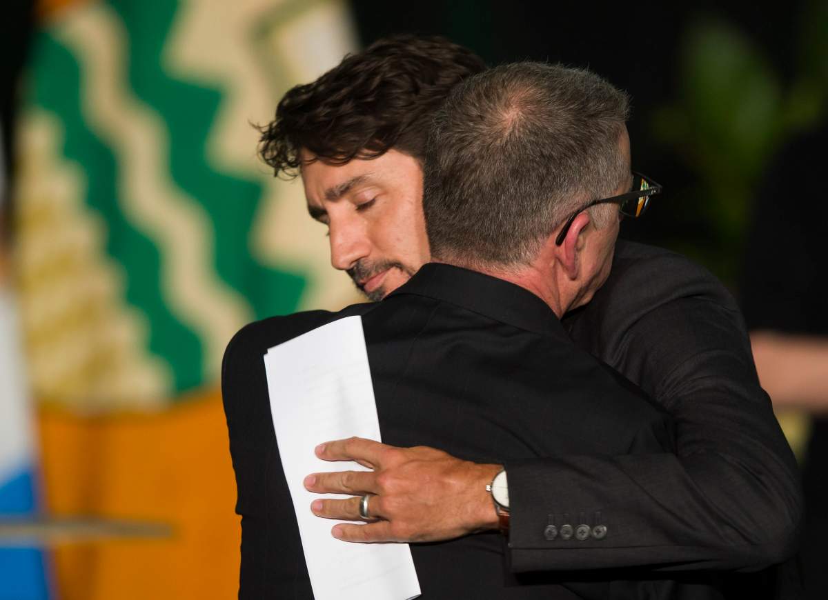 Prime Minister Justin Trudeau hugs University of Alberta President David Turpin during a memorial for the victims of the Ukrainian plane disaster in Iran this past week in Edmonton, Sunday, Jan. 12, 2020.