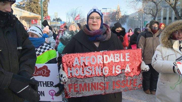 One marcher holds up a sign reading, “Affordable housing is a feminism issue”.