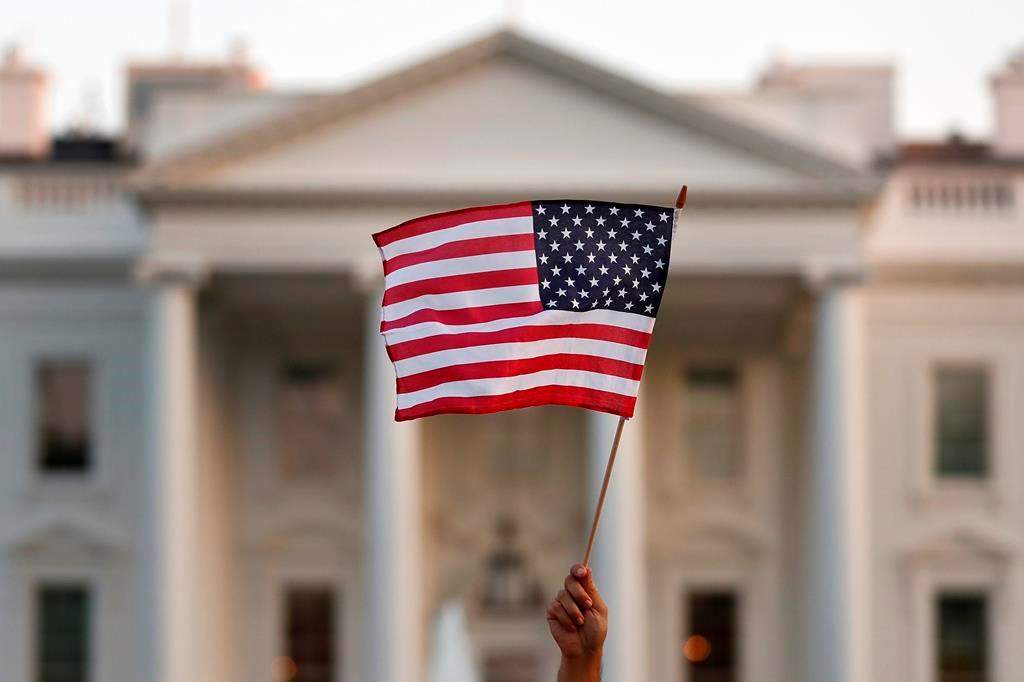 In this Sept. 2017 file photo, a flag is waved during an immigration rally outside the White House, in Washington.