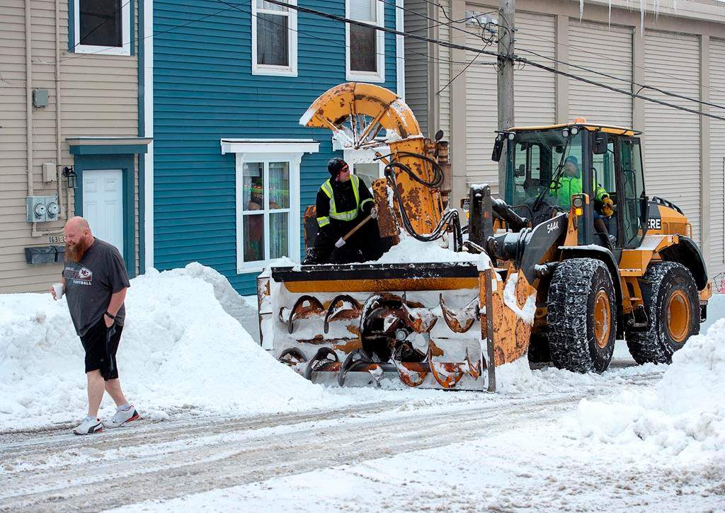 A resident heads back to his home after chatting with workers as they continue to remove snow from the streets in St. John’s on Tuesday, January 21, 2020.