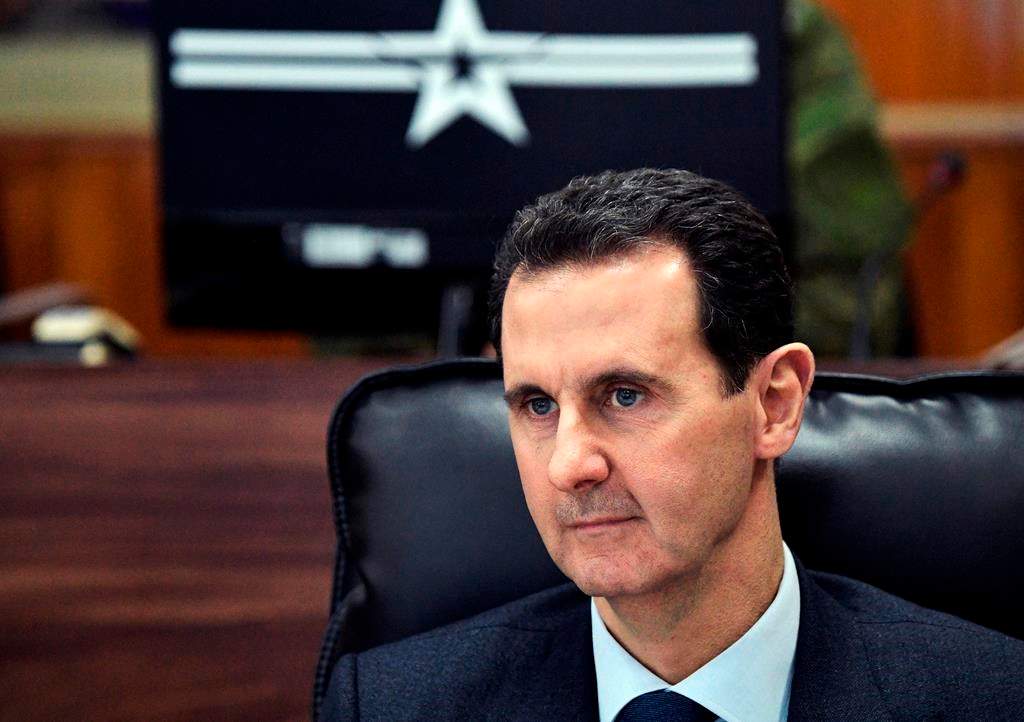 Syrian President Bashar Assad listens to Russian President Vladimir Putin during their meeting in Damascus, Syria, Jan. 7, 2020.