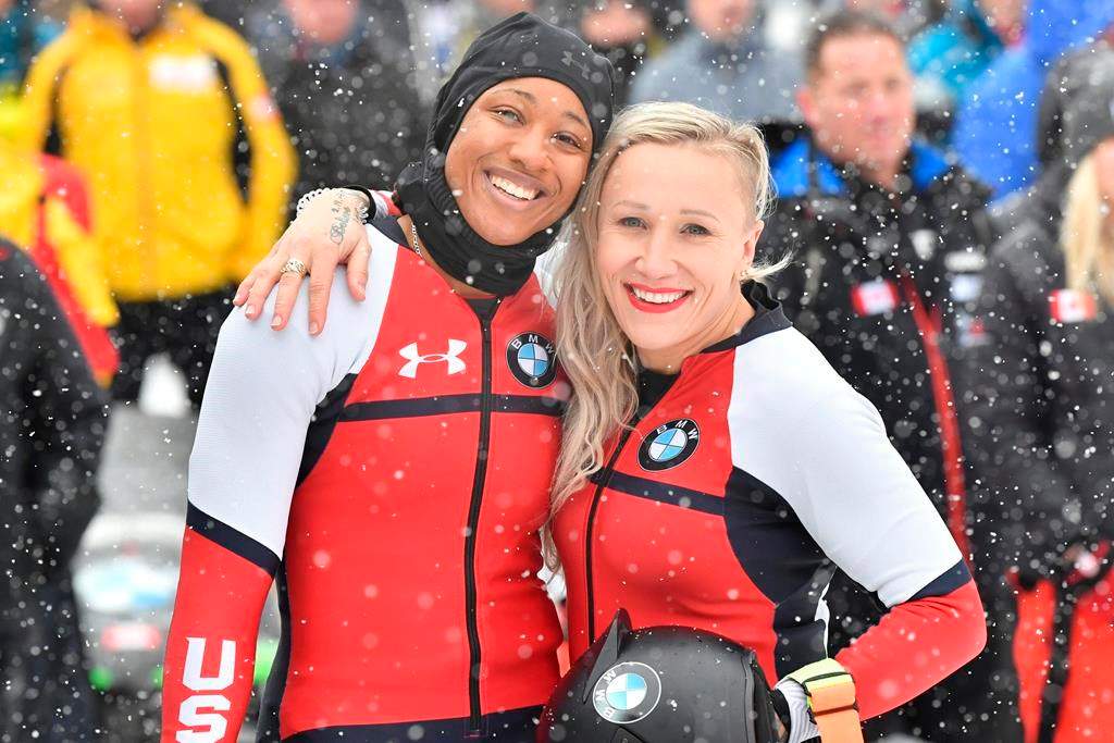 Third placed Kaillie Humphries and Sylvia Hoffmann, left, of the USA pose for media after their second run at the women’s two-man bobsled World Cup race in Igls, near Innsbruck, Austria, Saturday, Jan. 18, 2020. (AP Photo/Kerstin Joensson)