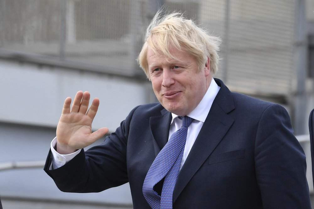 Britain's Prime Minister Boris Johnson, center, arrives for a cabinet meeting at National Glass Centre at the University of Sunderland, the city which was the first to back Brexit when results were announced after the 2016 referendum, in England, Friday, Jan. 31, 2020. Britain officially leaves the European Union on Friday after a debilitating political period that has bitterly divided the nation since the 2016 Brexit referendum. 