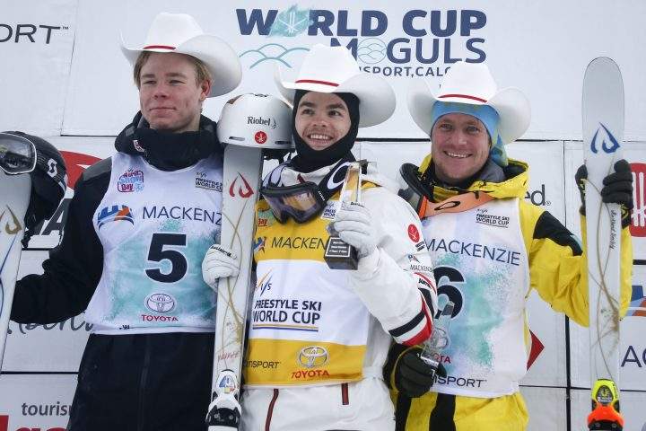 Canada’s Mikael Kingsbury, centre, celebrates his victory with second-place finisher Sweden’s Walter Wallberg, left, and third-place finisher Kazakhstan’s Dmitriy Reikherd following the men’s World Cup freestyle moguls event in Calgary, Alta., Saturday, Feb. 1, 2020.