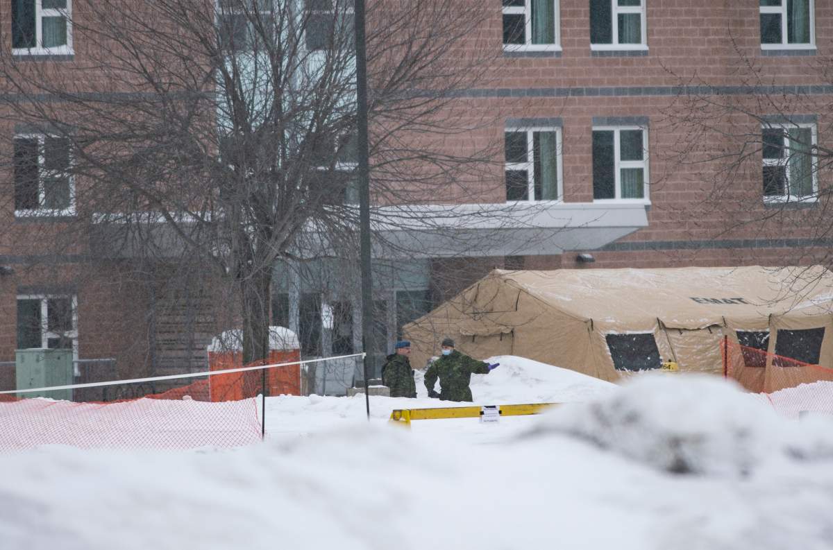 Canadian Forces members work outside the Yukon Lodge, which will temporarily house passengers from a charter flight that took 174 Canadian citizens from the centre of the global novel coronavirus outbreak in Wuhan, China at CFB Trenton in Trenton, Ont., on Friday, Feb. 7, 2020.