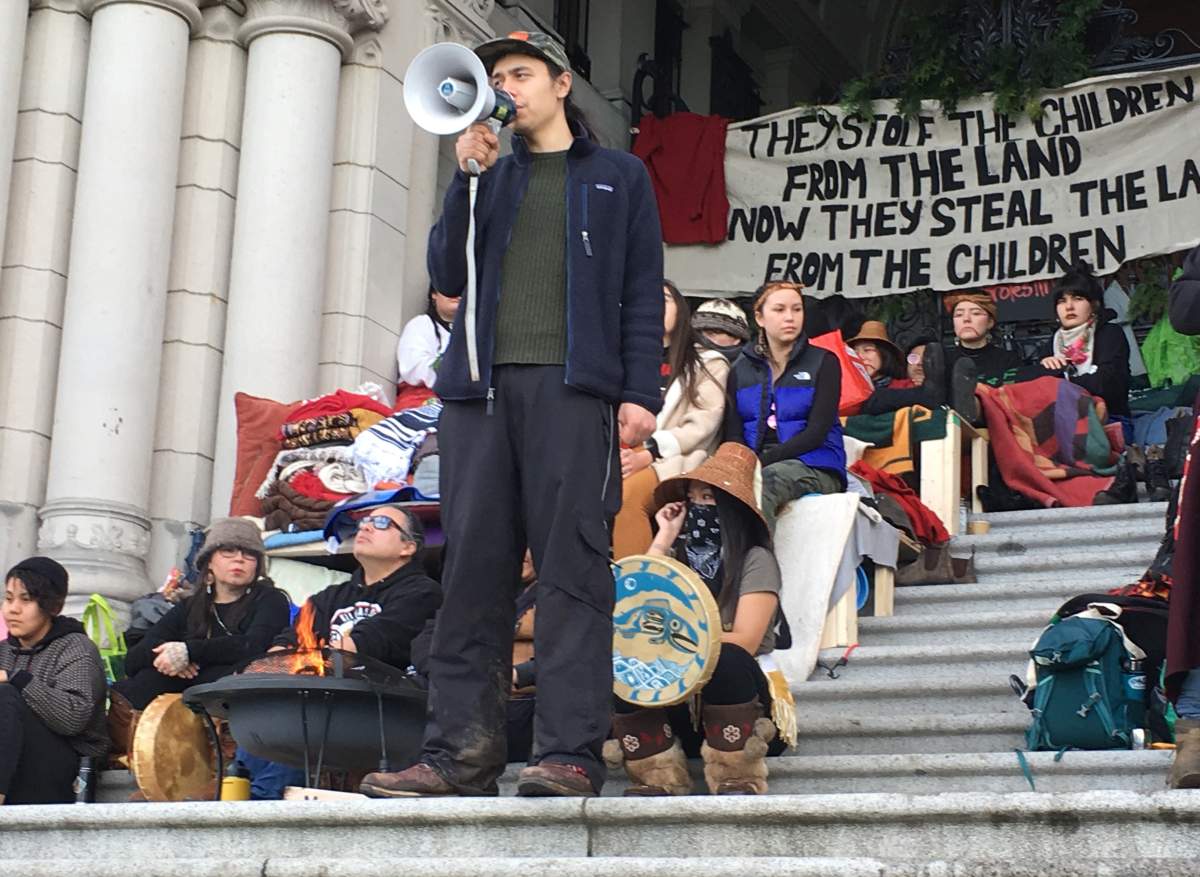 Indigenous pipeline protester Kolin Sutherland-Wilson speaks at an anti-pipeline rally in Victoria, Saturday, Feb. 8, 2020.