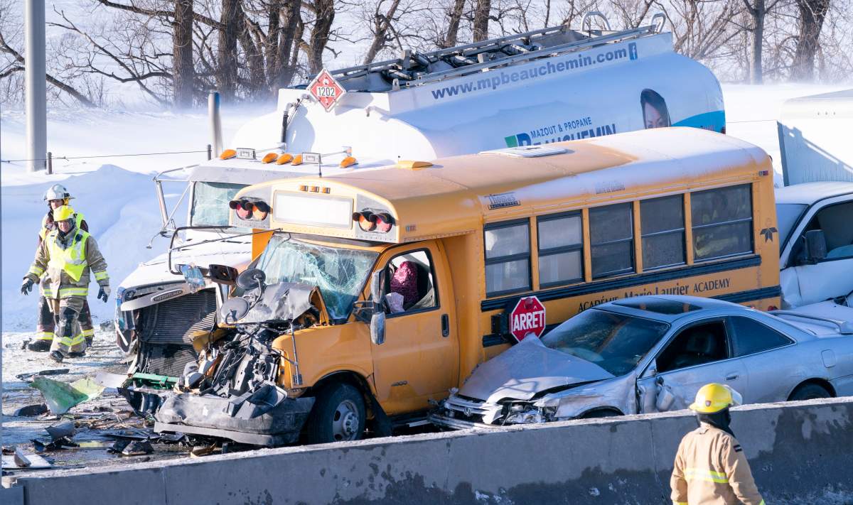 A fireman walks past a massive pileup involving numerous vehicles on the south shore of Montreal in La Prairie, Que. on Wednesday, February 19, 2020.