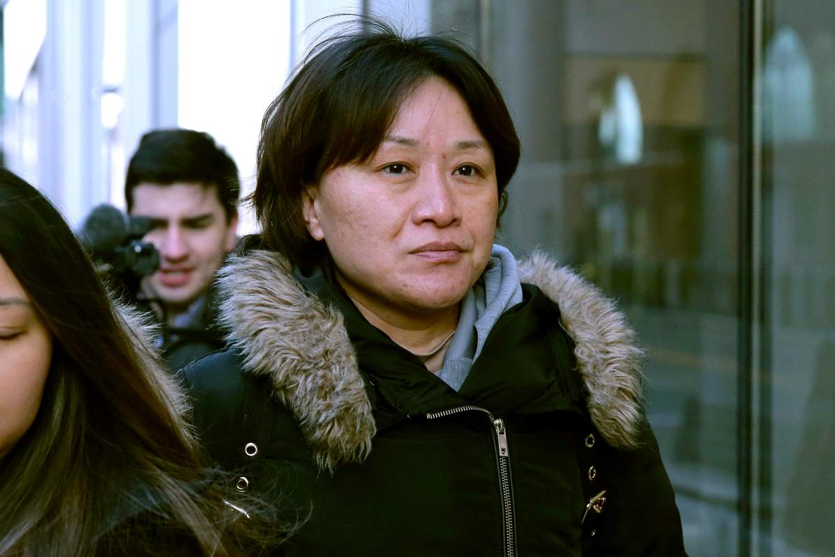 Xiaoning Sui, a Chinese national residing in British Columbia, Canada, leaves federal court, Friday, Feb. 21, 2020, in Boston, after pleading guilty to paying $400,000 to get her son into the University of California, Los Angeles, as a fake soccer recruit. 