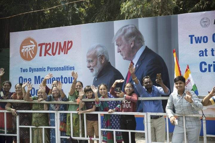 People line the street as the motorcade for U.S. President Donald Trump heads to a “Namaste Trump,” event at Sardar Patel Gujarat Stadium, Monday, Feb. 24, 2020, in Ahmedabad, India.