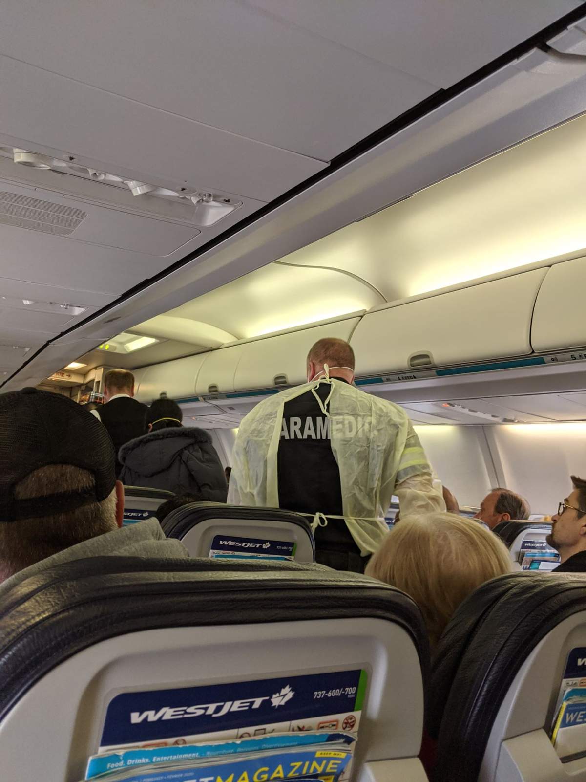Paramedics on a flight at Winnipeg’s airport where a person was taken off with a possible case of COVID-19.
