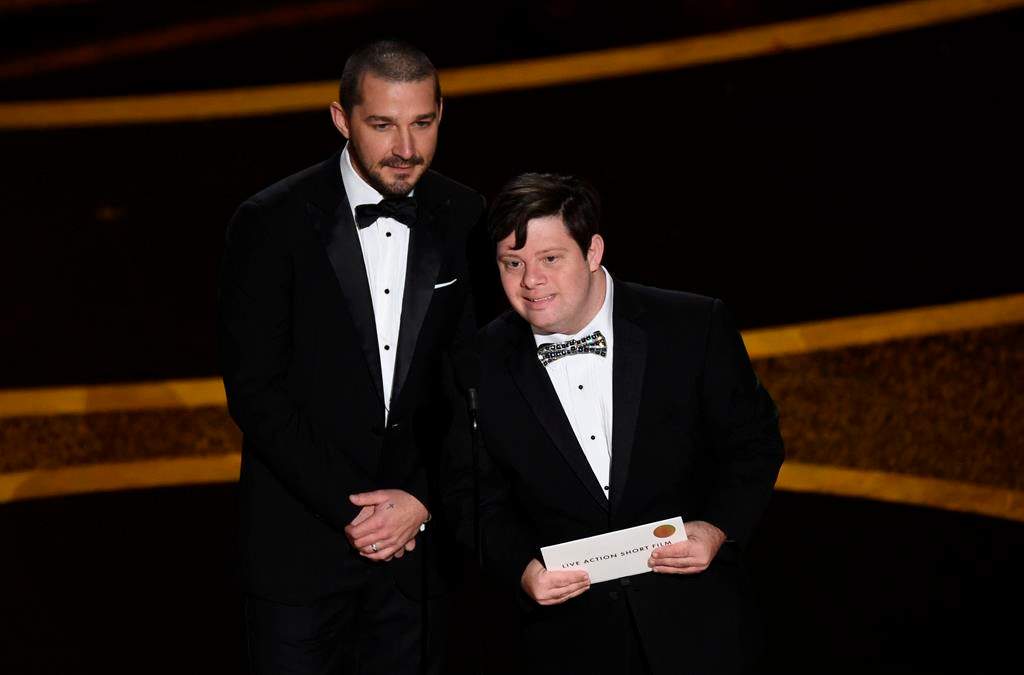 Shia LaBeouf, left, and Zack Gottsagen present the award for Best Live-Action Short Film at the Oscars on Sunday, Feb. 9, 2020, at the Dolby Theatre in Los Angeles. (AP Photo/Chris Pizzello)