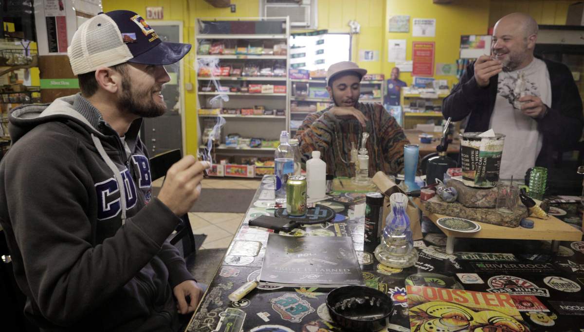 Daniel Jordan, of Tampa, Fla., left, Giobanni Turner, St. Albans, N.Y., center, and Frankie Turck , of Denver, smoke marijuana at iBake smoking lounge on Tuesday, April 25, 2017 in Denver. 