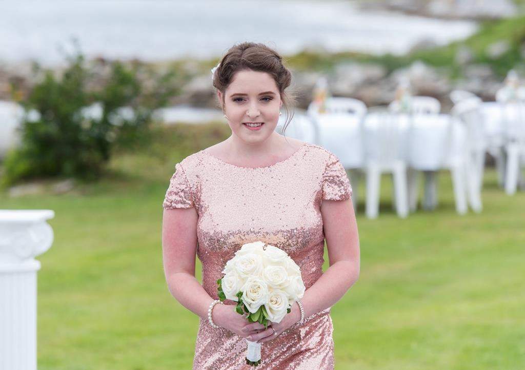 Chantelle Lindsay takes part in her friend Kayla McNutt's wedding in this handout photo. The father of a Nova Scotia woman with cystic fibrosis says the Canadian government's "chess game" with the pharmaceutical industry cost his daughter her life.