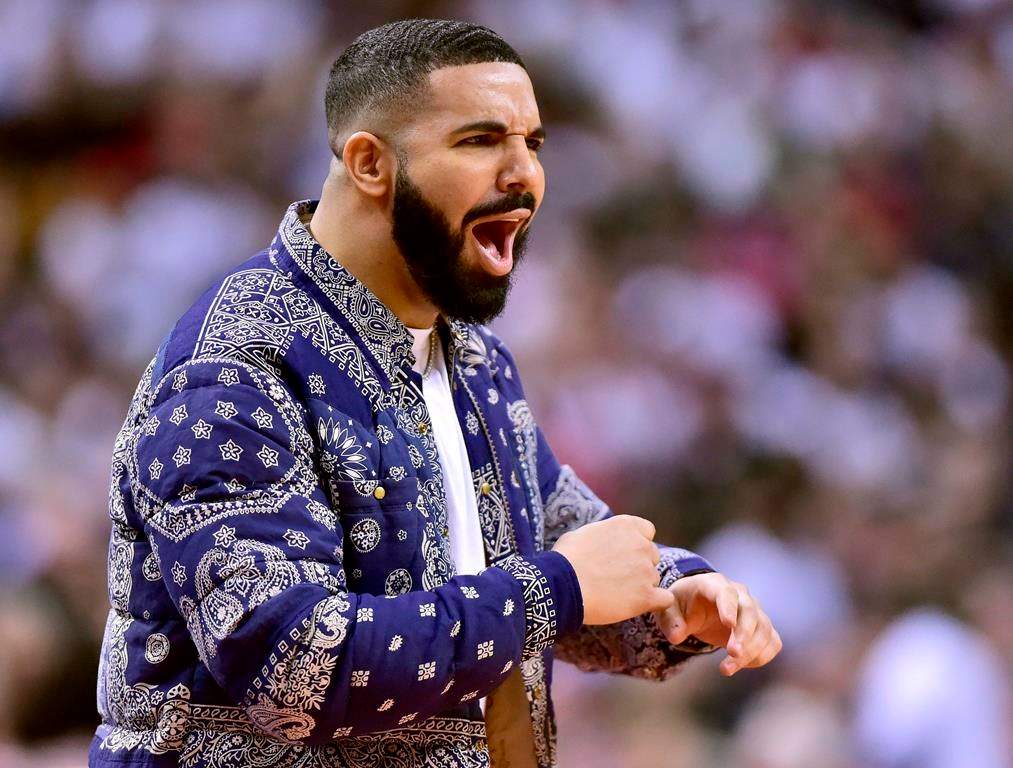 Drake reacts from courtside during the second half of Game 1 of a second-round NBA basketball playoff series between the Toronto Raptors and the Philadelphia 76ers in Toronto, Saturday, April 27, 2019.
