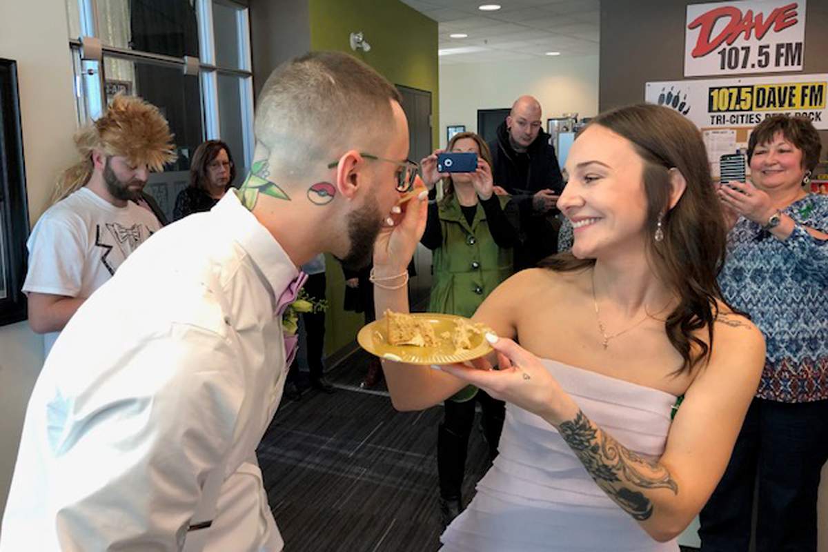 Lauren Hunter and Kyle Gutscher share some cake after getting hitched in the Dave Rocks studio.