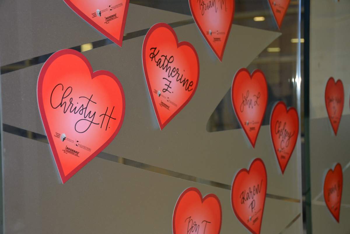 Heart stickers with the name of donors on the Heart Wall at the Mazankowski Alberta Heart Institute.