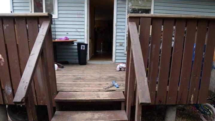 The deck of Tyler Applegate’s home, including the chain dog leash his partner said he wrapped around his arm.