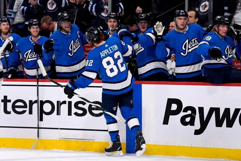 The Winnipeg Jets’ Mason Appleton (82) celebrates his goal with teammates on the bench. THE CANADIAN PRESS/Fred Greenslade