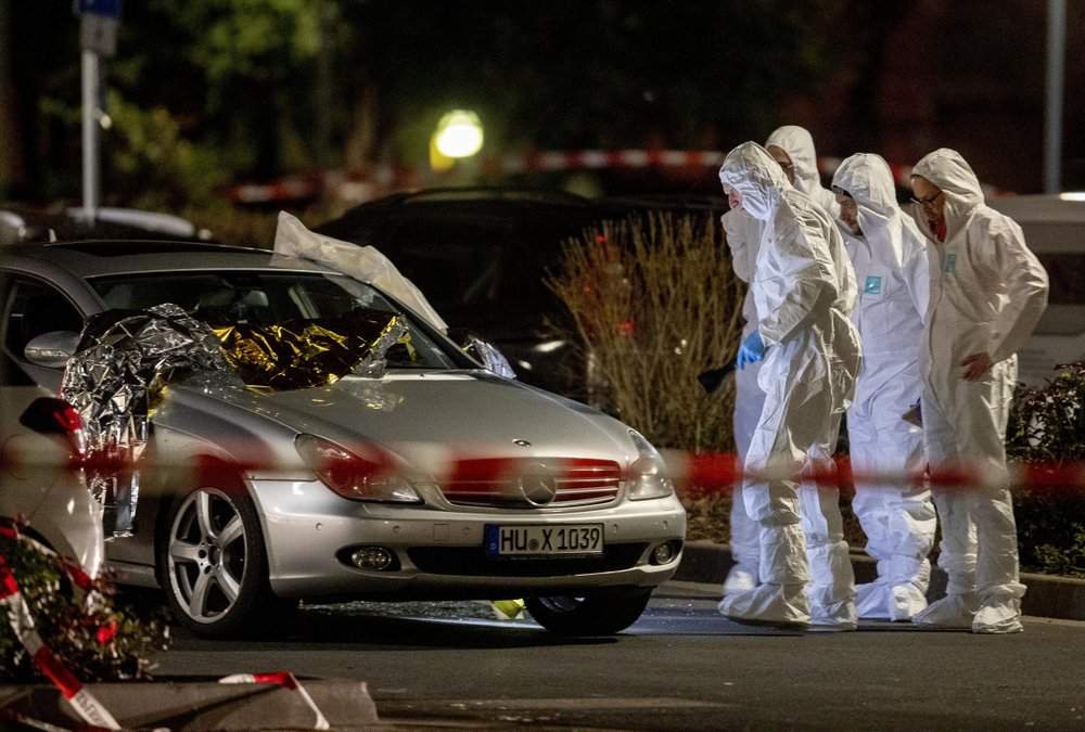 Forensics investigate at the scene after a shooting in central Hanau, Germany Thursday, Feb. 20, 2020. Eight people were killed in shootings in the German city of Hanau on Wednesday evening, authorities said. (AP Photo/Michael Probst)