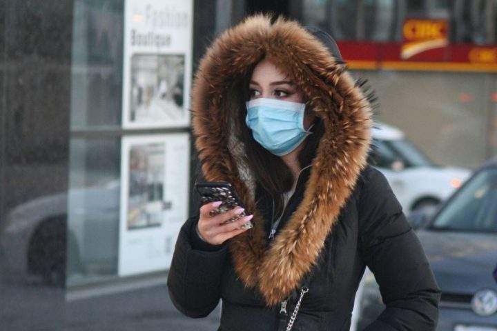 A pedestrian wears a face mask in Toronto on Jan. 29, 2020.