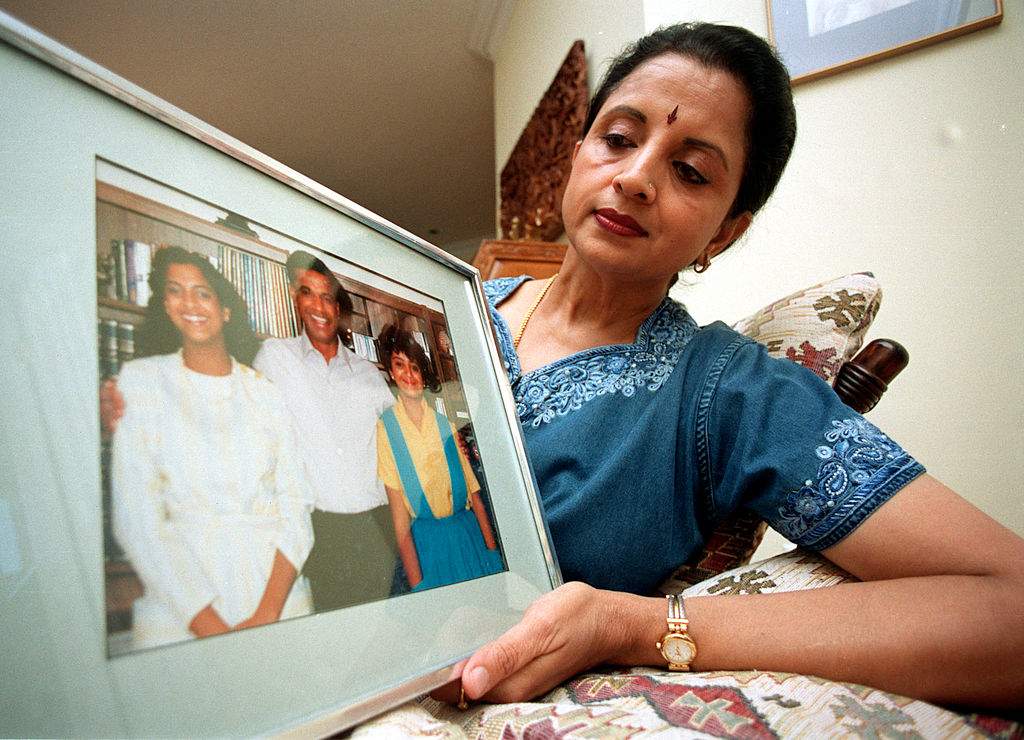 In this 2010 photo, Lata Pada displays a picture of her daughters Brinda (L) and Arti (R) and husband Vishnu. All three died in the 1985 Air India bombing. (Photo by Rick Eglinton/Toronto Star via Getty Images)