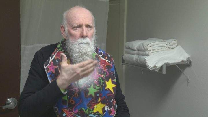 Madsen spray paints his beard white before using stencils to create logos.