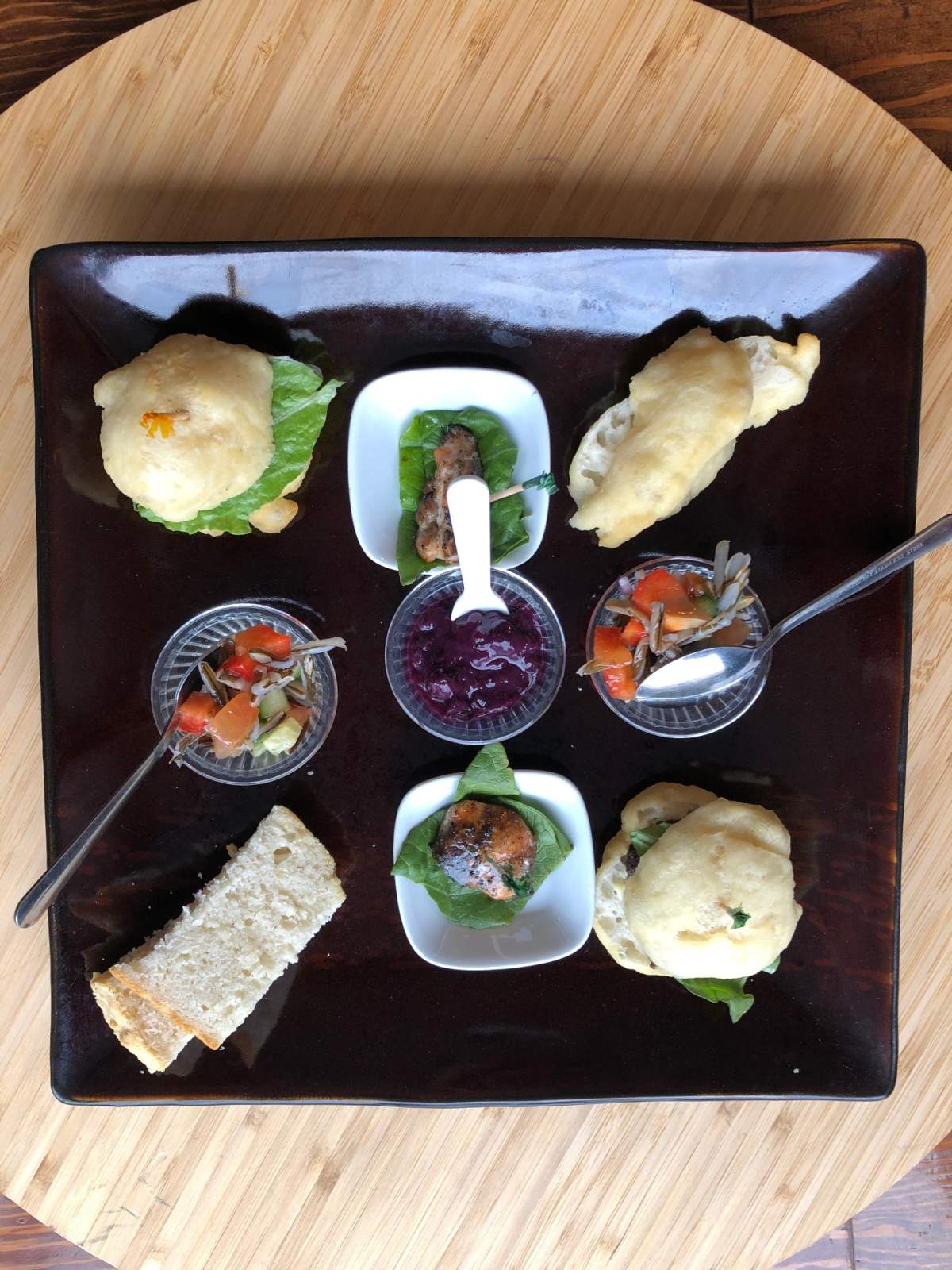 The bannock sampler platter features wild blueberry jam, bannock, bison sliders, wild rice and Arctic char.