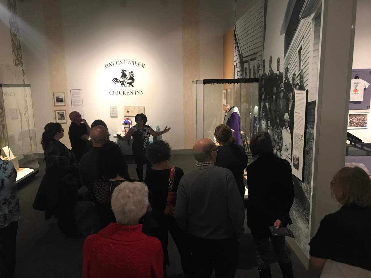 Standing in front of a re-creation of Hatti’s Harlem Chicken Inn, Deborah Dobbins gives a tour of a RAM exhibit highlighting stories of African American Albertans.