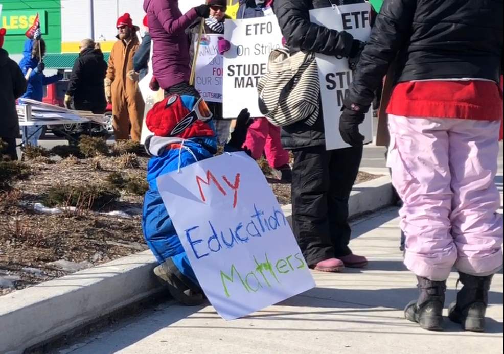 Child at St Thomas teachers strike supporting his mom who is a teacher.