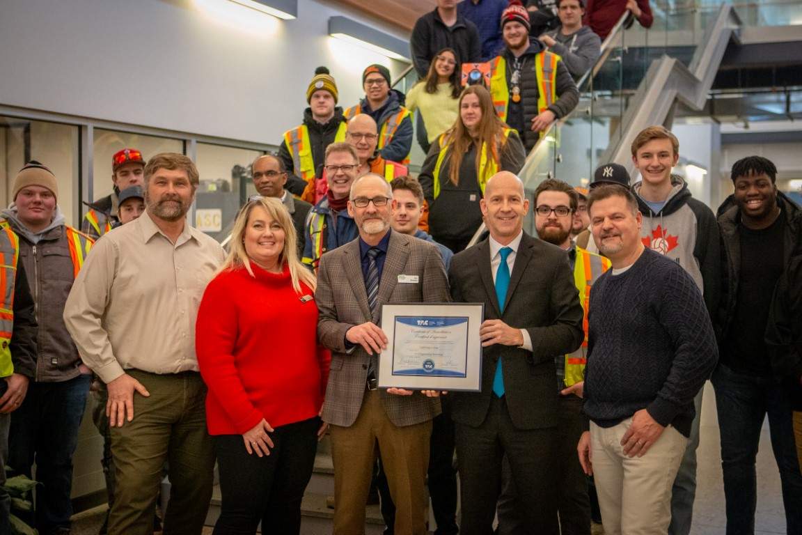 Officials from Lethbridge College pose with the new national accreditation for the Civil Engineering Technology program.