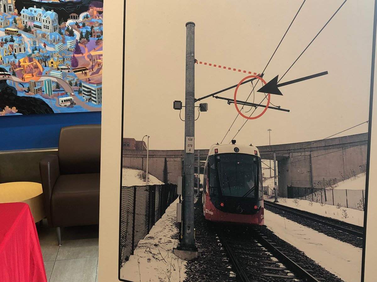An OC Transpo poster depicts what part of the LRT’s overhead catenary system broke loose on Wednesday. The fallen cable is circled in red and the dotted line shows where it should have been attached.