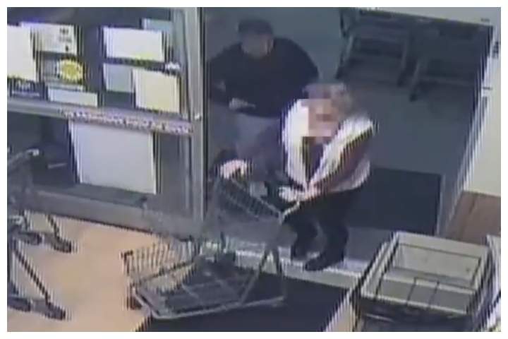A man is shown holding a suspected syringe before jabbing it into the woman shown at a grocery store in Churchton, Md., on Feb. 18, 2020.