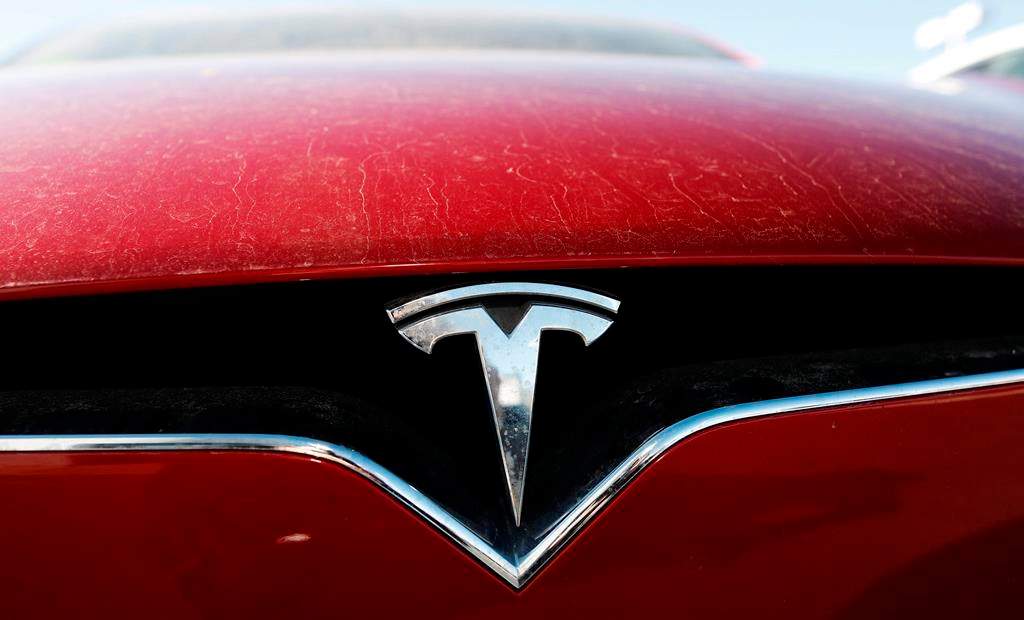 FILE - In this Feb. 2, 2020, file photo, the company logo shines on the grille of an unsold 2020 Model X at a Tesla dealership in Littleton, Colo. Tesla is now worth more than General Motors, Ford and Fiat Chrysler combined, even though the Big Three together sell more cars and trucks in two weeks than Tesla does in a whole year. (AP Photo/David Zalubowski, File).