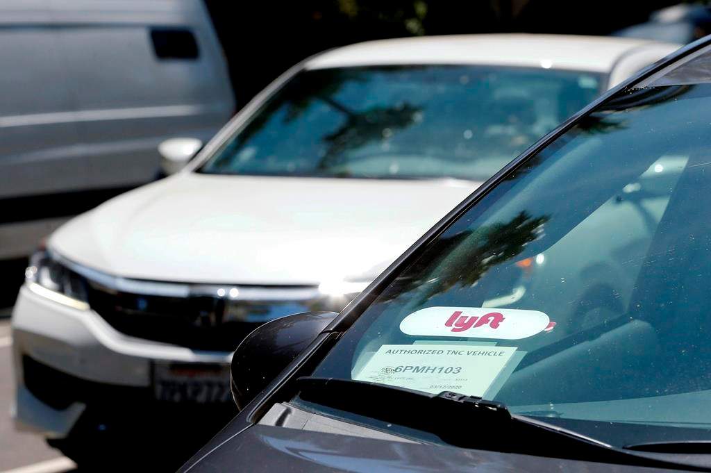 FILE - In this July 9, 2019, file photo a Lyft ride-share car waits at a stoplight in Sacramento, Calif.