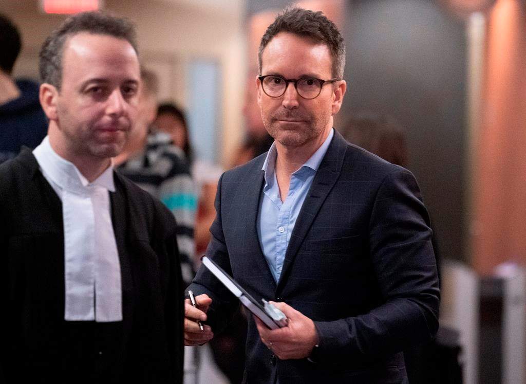 Former radio and television personality Éric Salvail walks the halls of the courthouse in Montreal on Monday, February 17, 2020.