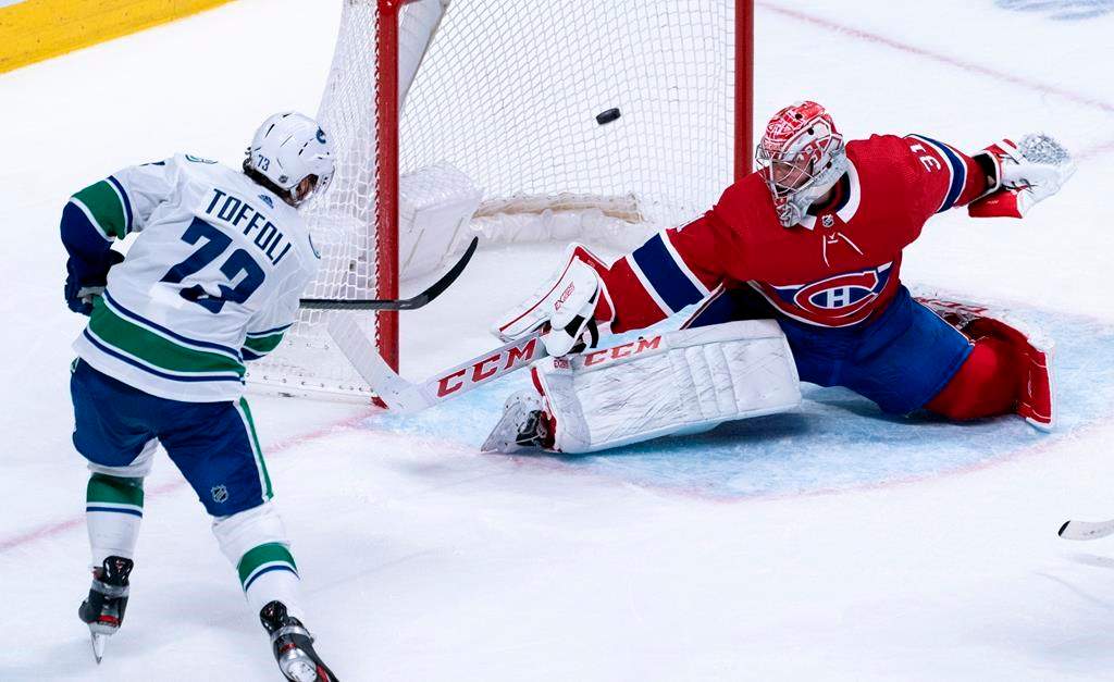 Vancouver Canucks' Tyler Toffoli scores past Montreal Canadiens goaltender Carey Price during overtime NHL hockey action in Montreal, Tuesday, Feb. 25, 2020. THE CANADIAN PRESS/Paul Chiasson.