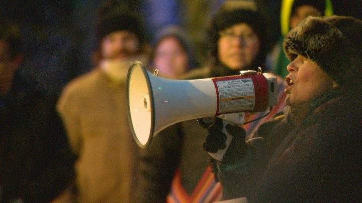 Wendy Lynn Lerat, a co-organizer of Saturday’s protest speaks to a crow on Feb. 15