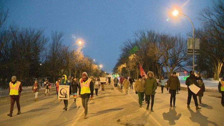 Protesters march north on Albert Street toward 14th Avenue