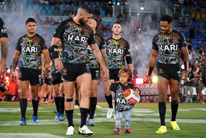 Quaden Bayles (C, right) leads the Indigenous All Stars on to the field with captain Joel Thompson (c, left) during the National Rugby League (NRL) Indigenous All-Stars vs Maori Kiwis match at Cbus Super Stadium on the Gold Coast, Australia, 22 February 2020.