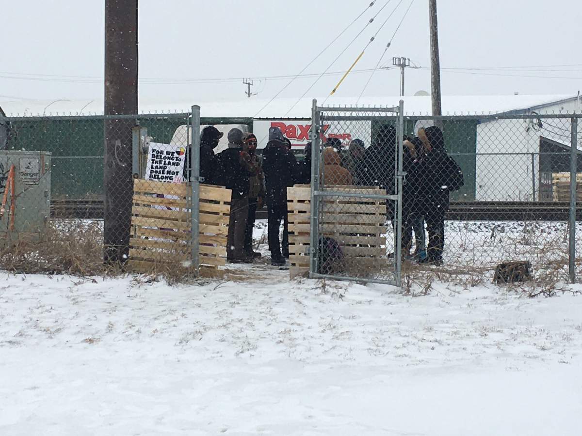 Protesters stand at the edge of the Gardiners Road rail overpass Thursday morning.