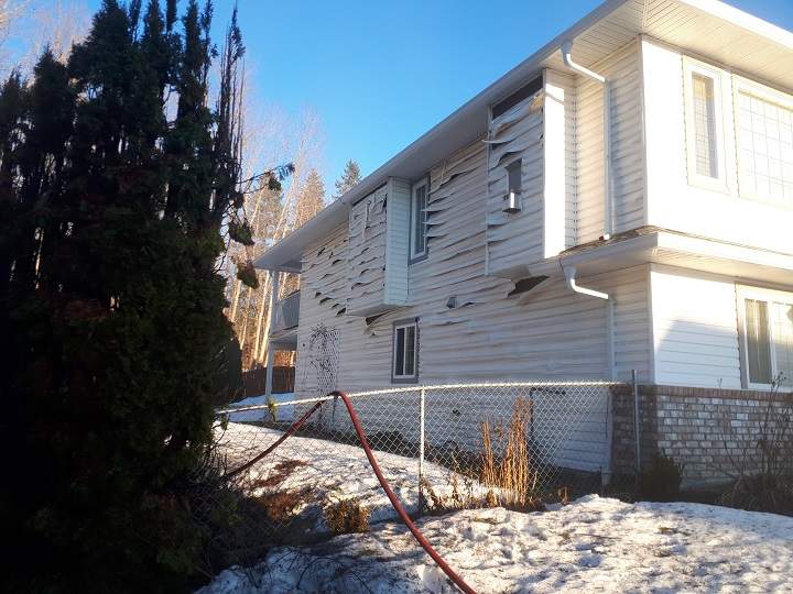 Heat from the hedge fire damaged siding on a nearby home.