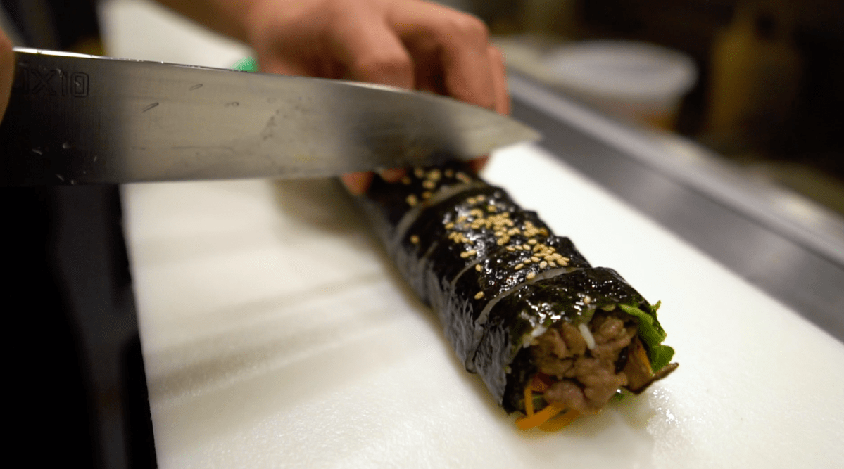 Sesame oil-coated dry seaweed rice roll filled with bulgogi, carrots, lettuce, perilla leaves, sautéed onions and shiitake mushrooms.