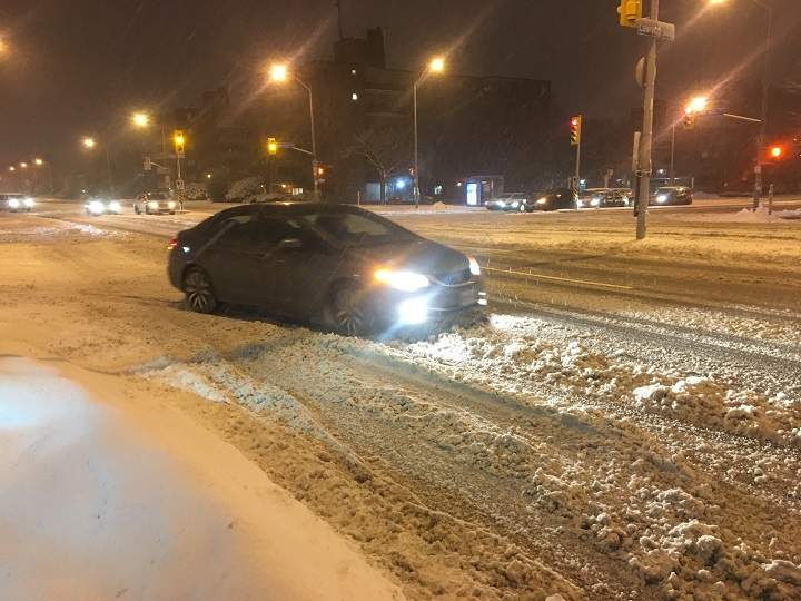 Drivers on Toronto roads as snow and rain fall over the city on Tuesday morning.